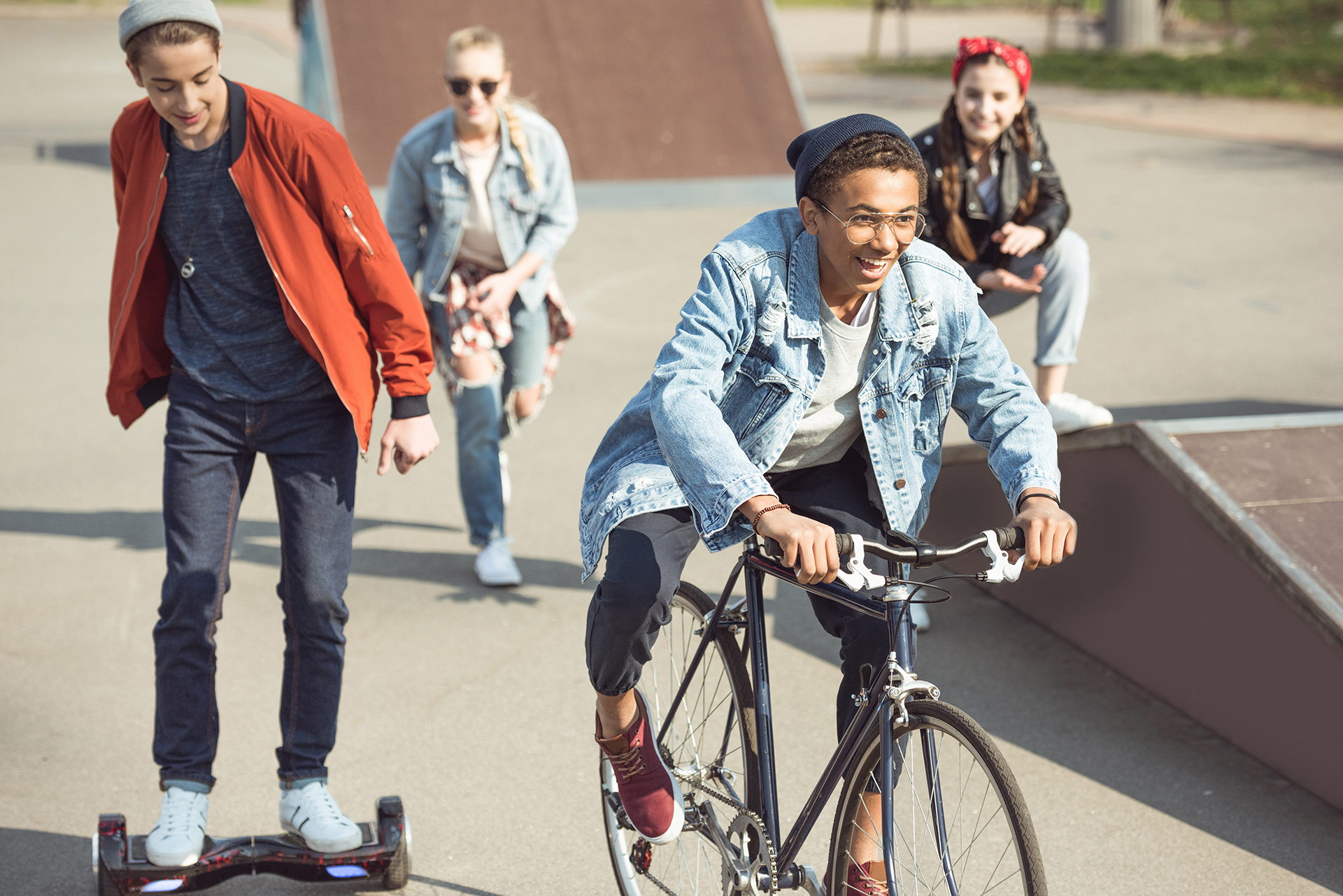stylish teenagers spending time in skateboard park, teenagers having fun concept